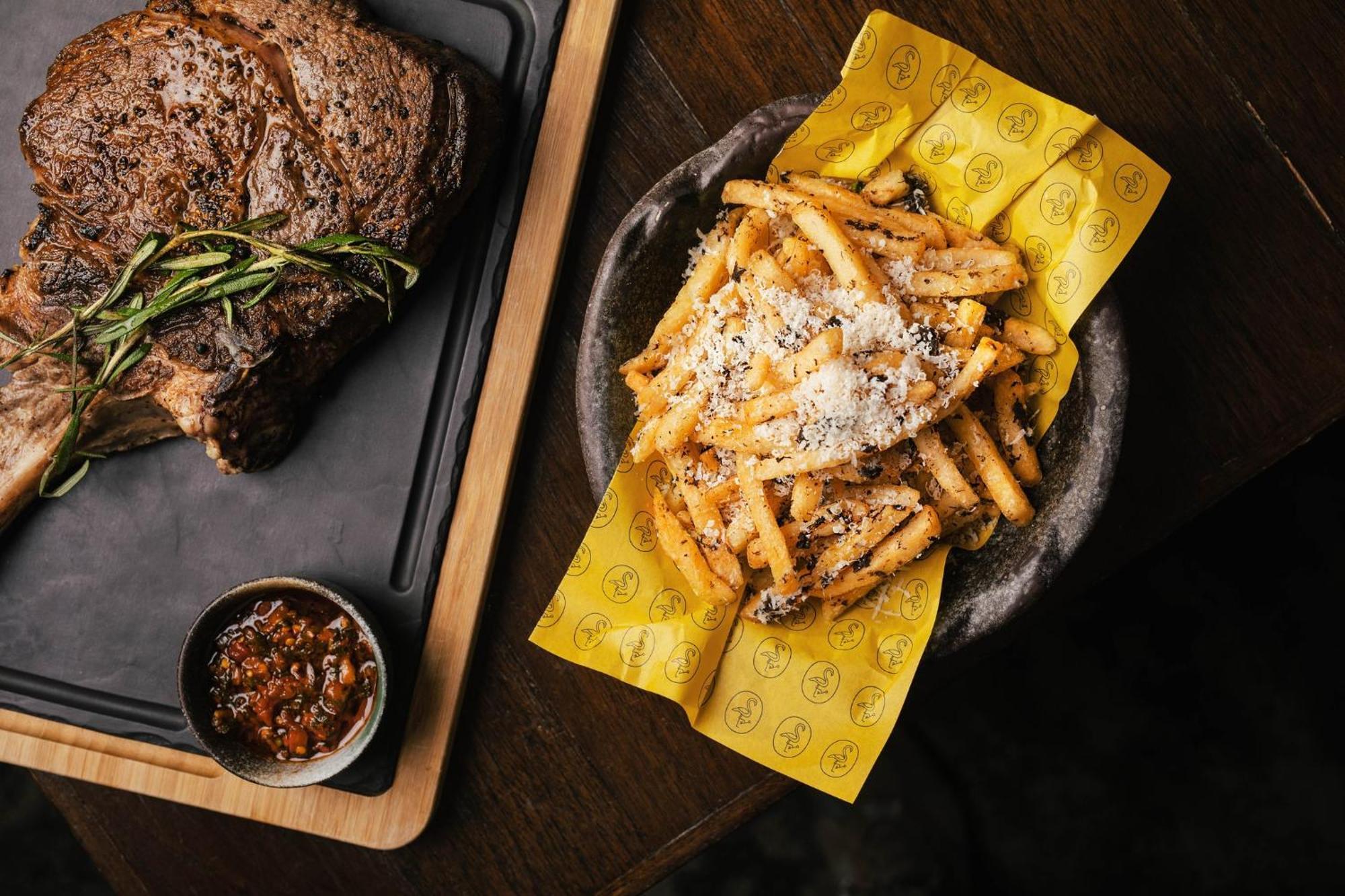 Voco Orchard Singapore By Ihg Экстерьер фото A plate of chips and steak